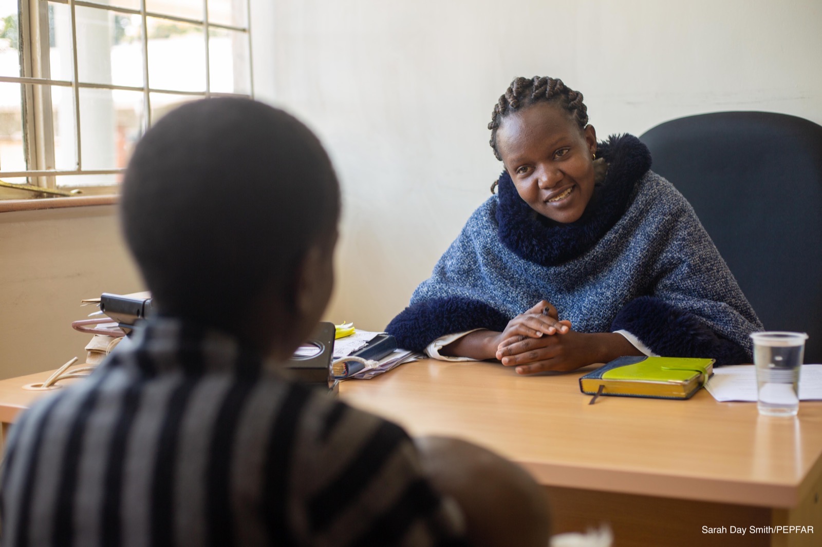 Clinician reviewing records with a patient in a facility office